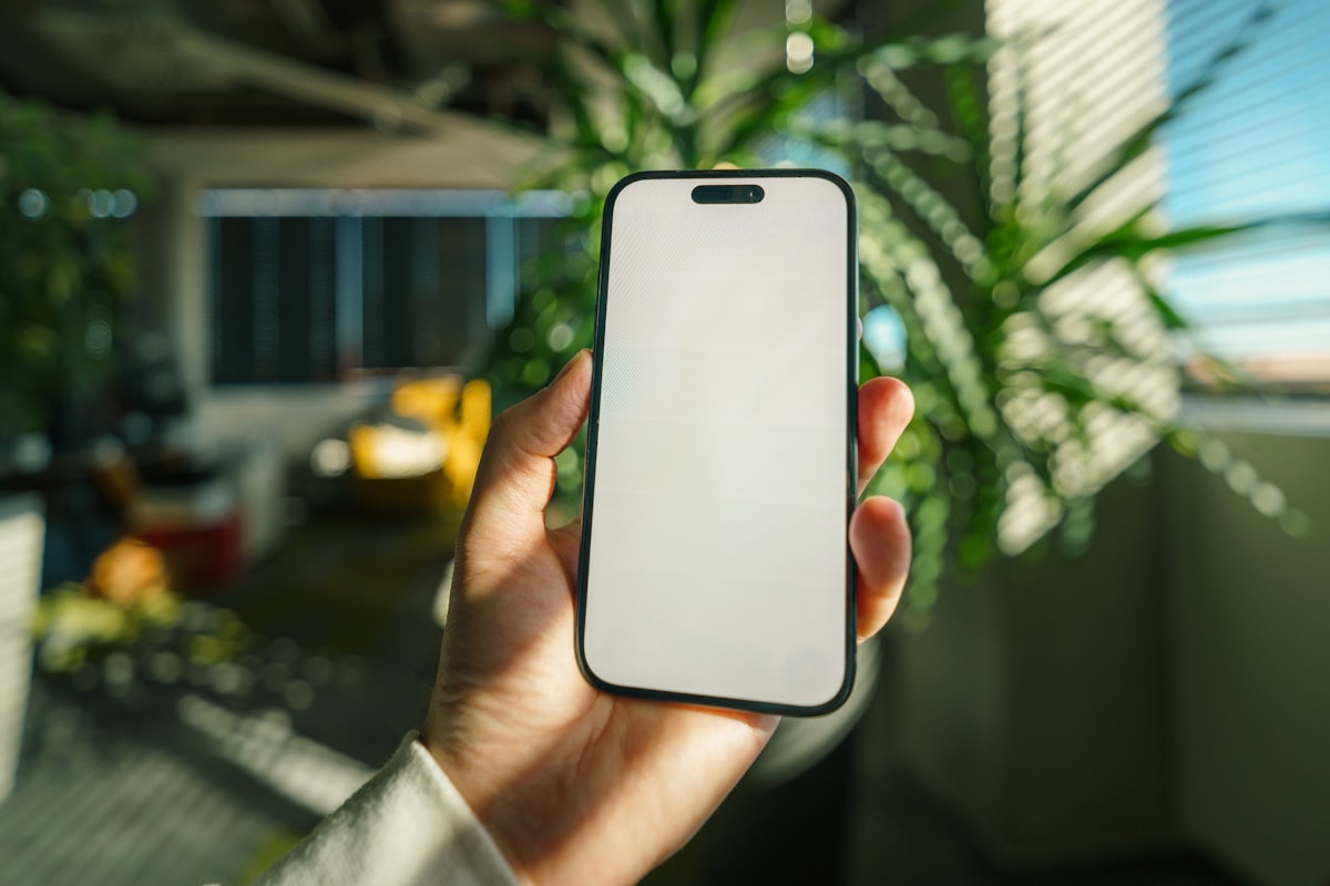 A hand holding a smartphone