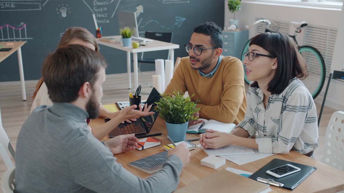 A team reviewing plans together around a table