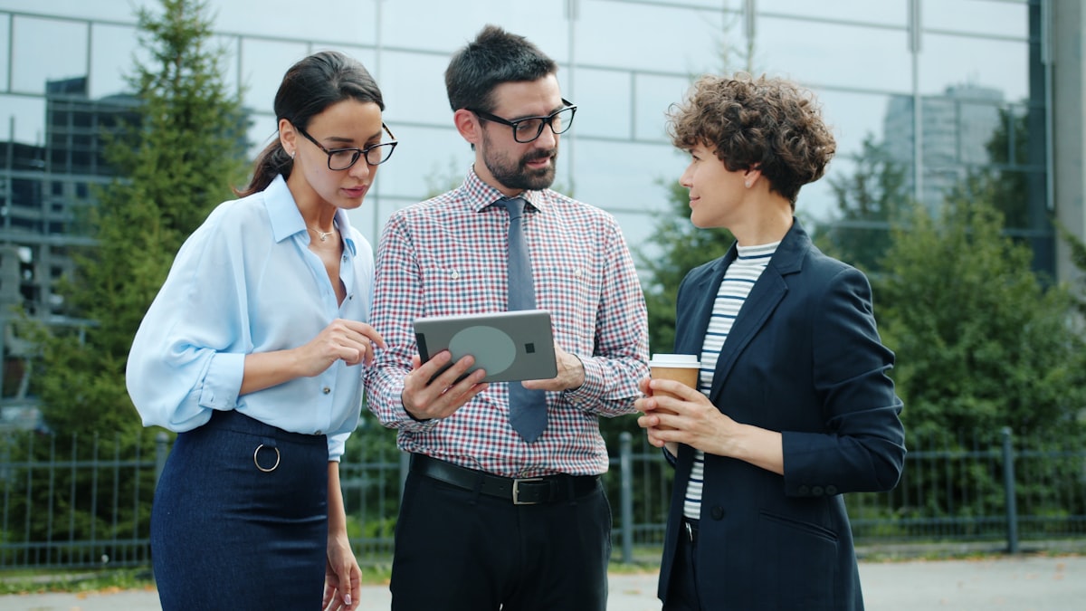Colleagues reviewing a tablet together outdoors