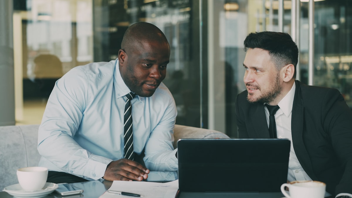 Two colleagues discussing documents